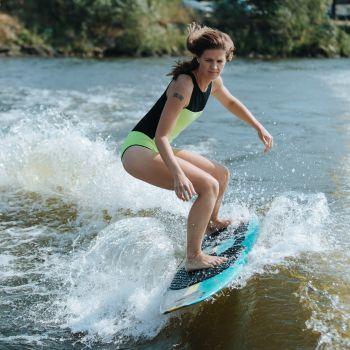Girl Surfing on a Wakesurf Board Behind the Boat