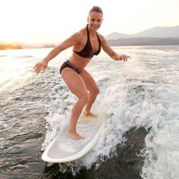 Woman Wakesurfing Surf-Style Without a Rope